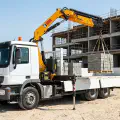 Crane-mounted truck delivering precast concrete units in the UAE